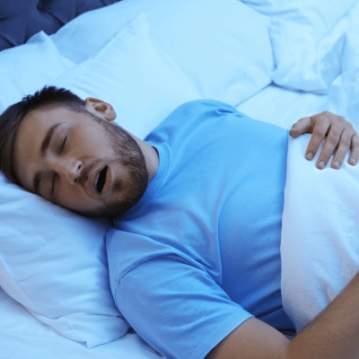 Man sleeping in bed, representing sleep apnea