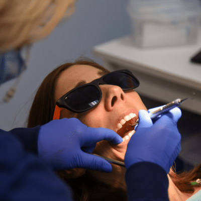 A woman getting her teeth checked, representing dental implants