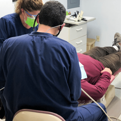Beach dental center dentist working on a patient, representing what to expect at an emergency dental appointment