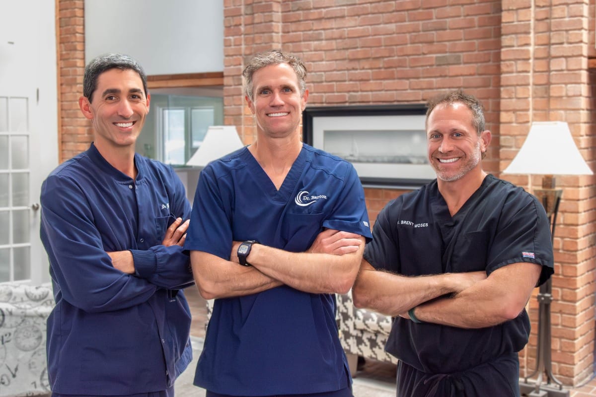 Beach-dental-center-dentist-team-photo Dr. Gigliotti, dr. Barton, and dr. Moses smiling inside beach dental center, a family and cosmetic dentistry office in virginia beach.